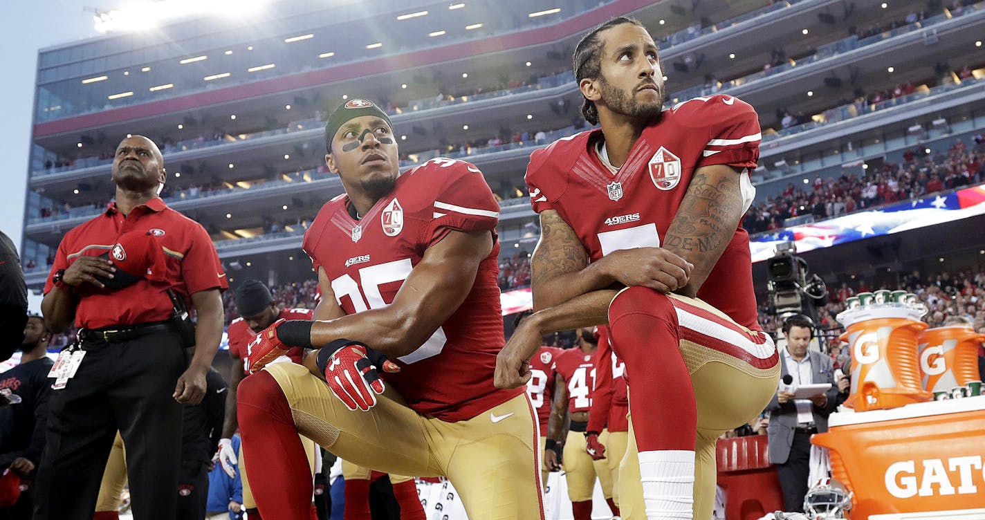 FILE - In this Monday, Sept. 12, 2016, file photo, San Francisco 49ers safety Eric Reid (35) and quarterback Colin Kaepernick (7) kneel during the national anthem before an NFL football game against the Los Angeles Rams in Santa Clara, Calif. NFL owners have approved a new policy aimed at addressing the firestorm over national anthem protests, permitting players to stay in the locker room during the "The Star-Spangled Banner" but requiring them to stand if they come to the field. The decision wa