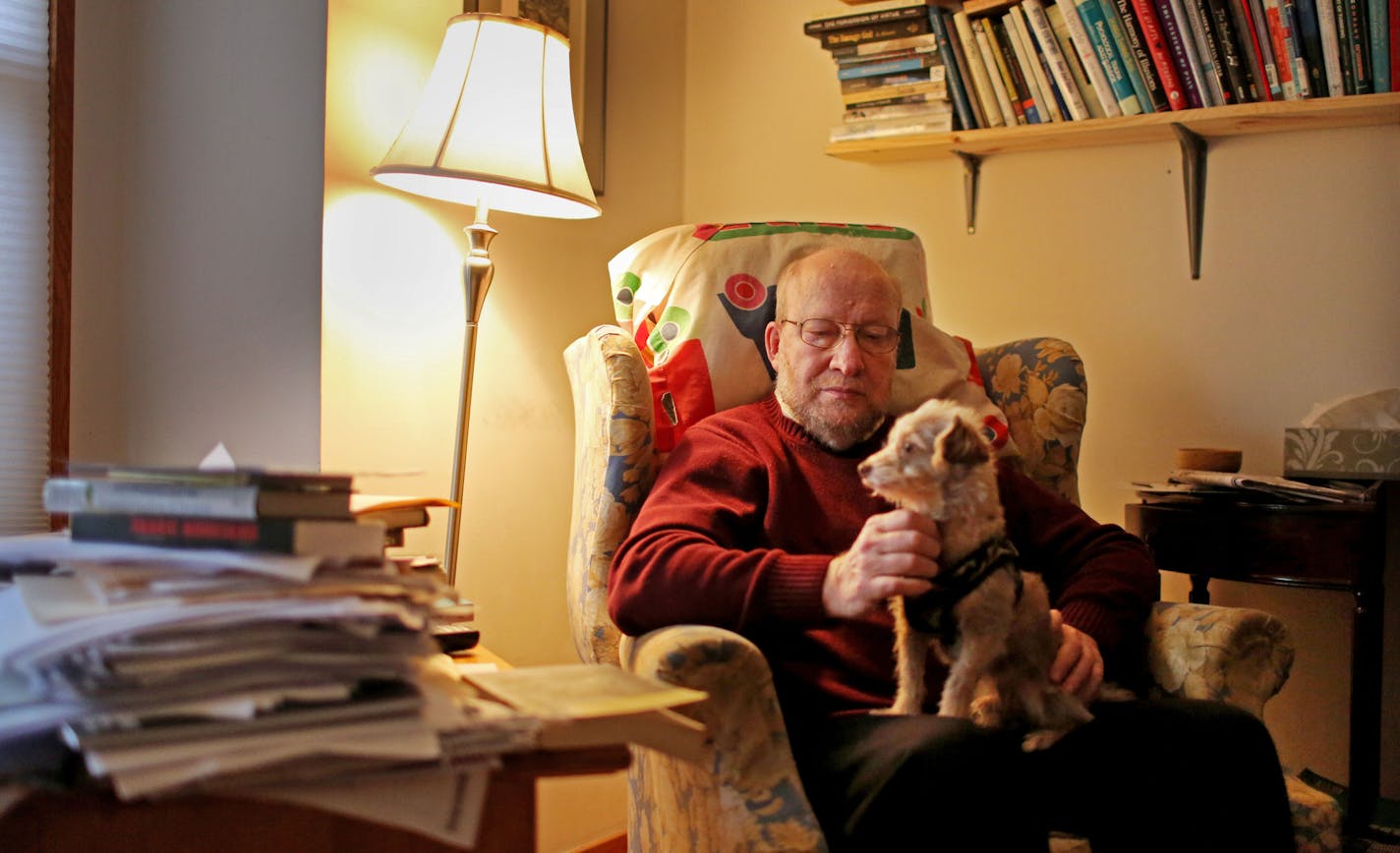 Mike Robin, 65, the only licensed medical therapist left at Complementary Support Services, poses for a portrait in his home with his male rescue dog Skippy Wednesday, Dec. 9, 2015, in St. Paul, MN. Robin, who has been a therapist for 35 years, believes the company has been running a scam benefiting two employees for about 10 years and that they submitted about 85,000 fraudulent bills and he estimated could have bilked the government out of $15 to $17 million over that time period.](DAVID JOLES/