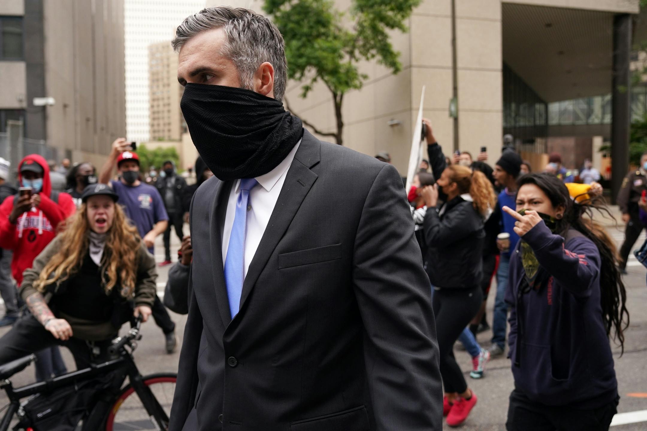 Former Minneapolis police officer Thomas Lane was screamed at by protesters as he walked to a car from the Hennepin County Family Justice Center following Friday's hearing.