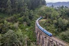 A train crosses the Nine Arches Bridge, near Ella, Sri Lanka. Navigating Sri Lanka's hill country by rail can be a beguiling experience but also a tim