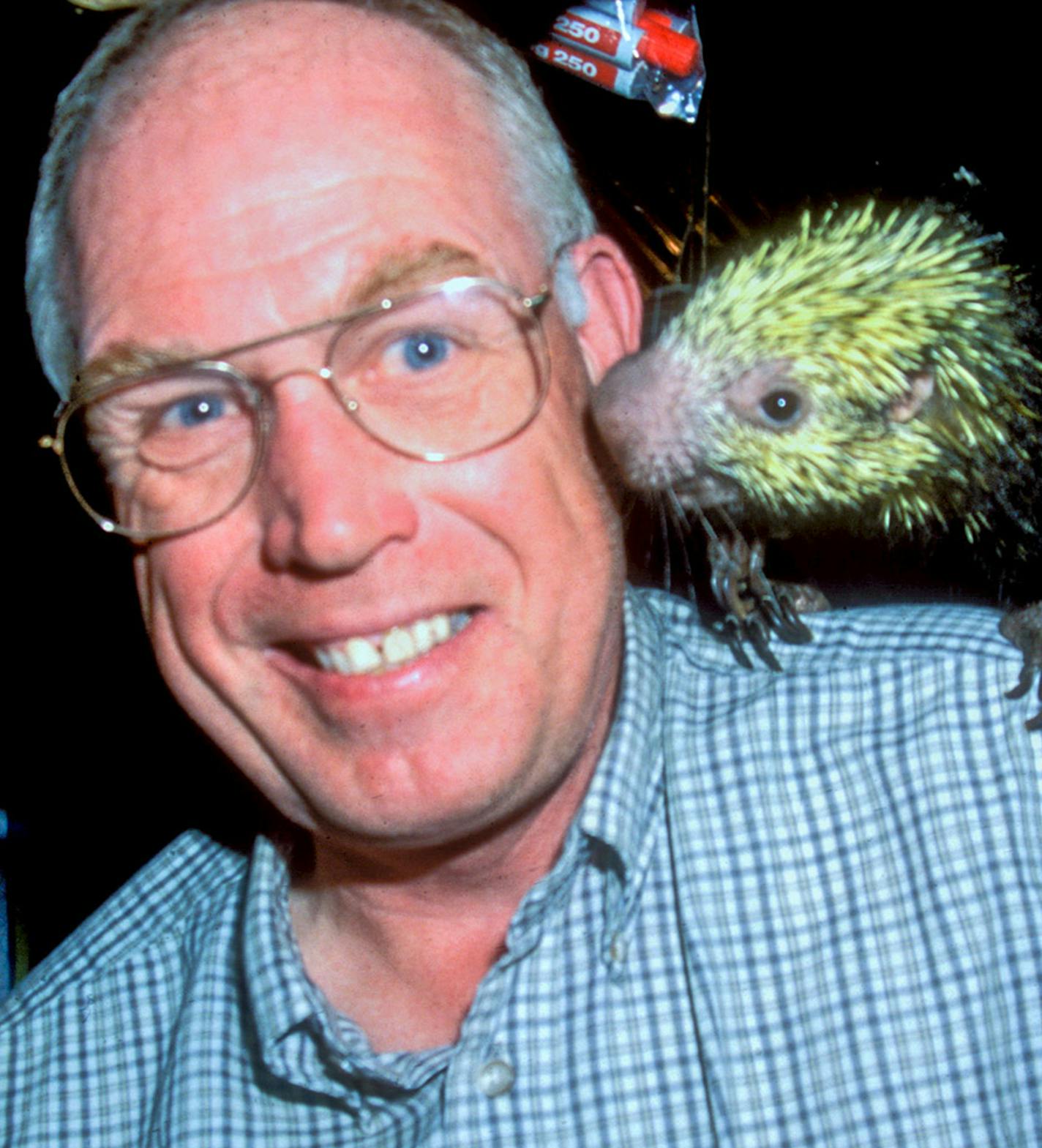 Carrol Henderson met his wife Ethelle during studies in Costa Rica. The couple has led scores of bird watching trips to the country. Here, on one of those trips, a tropical porcupine gets up close and personal with Henderson. The animal was raised as a pet in Costa Rica by a Minnesota biologist who is a friend of the Hendersons.