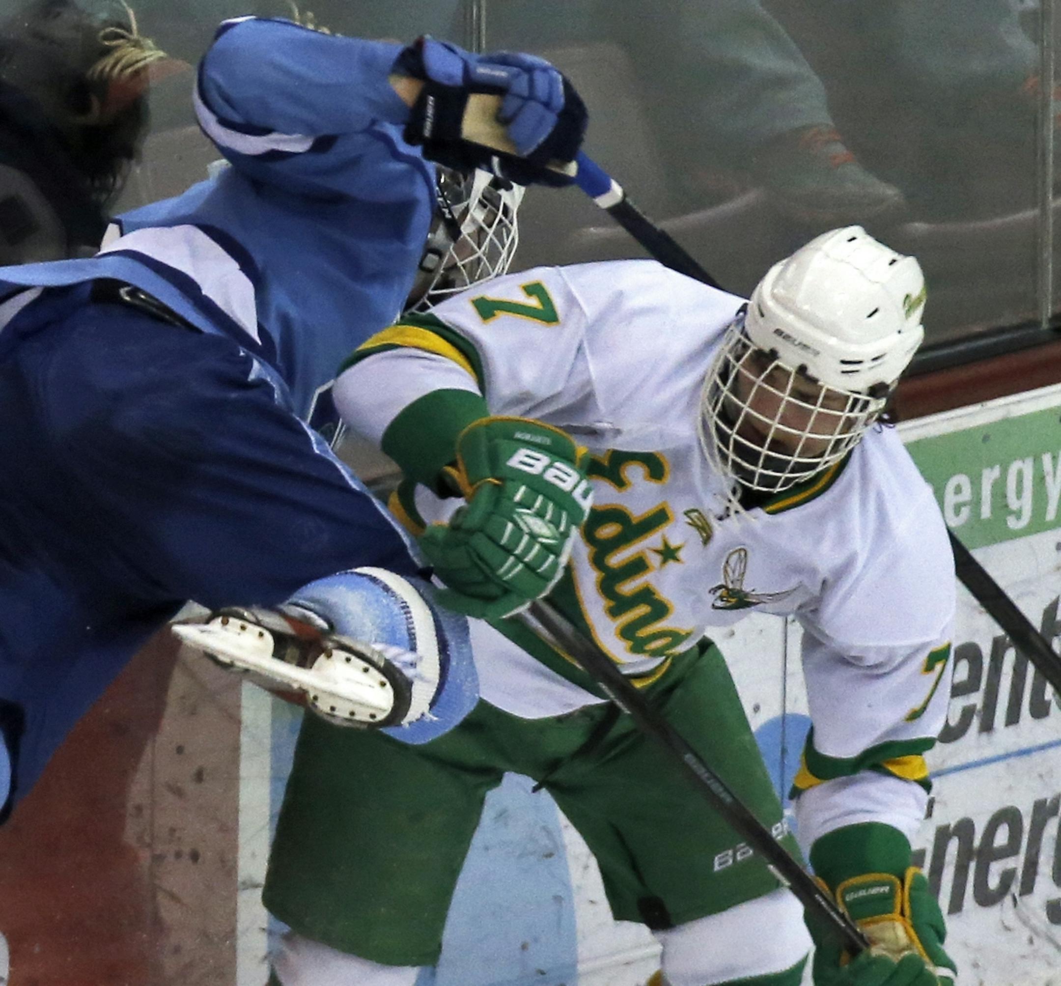 Jefferson's Cory Rickheim is sent flying into the boards by Edina's Kieffer Bellows (7) [ Class 2A Boys Hockey Section Finals - Edina Hornets vs. Bloomington Jefferson Jaguars. (MARLIN LEVISON/STARTRIBUNE(mlevison@startribune.com) ORG XMIT: MIN1402262244300266