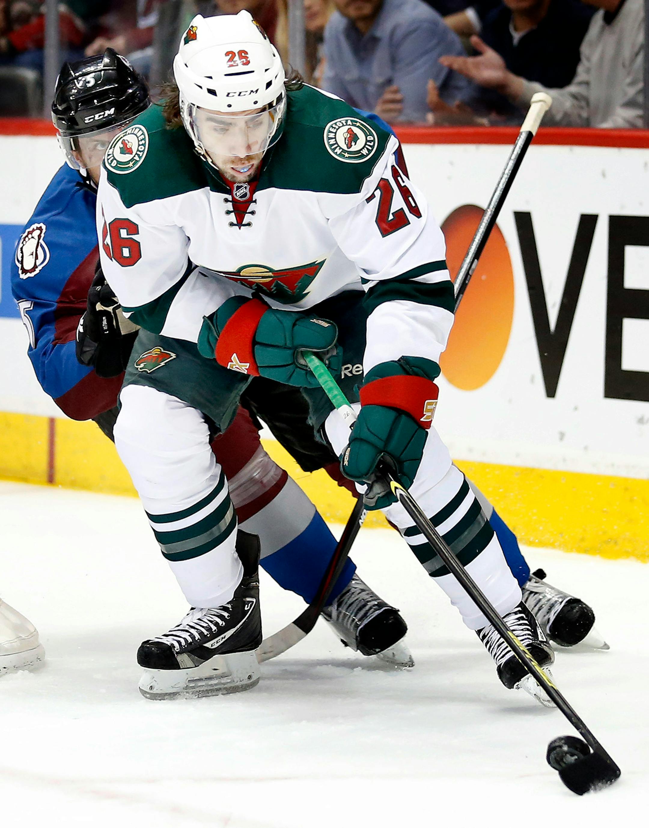 Nate Guenin (5) and Matt Moulson (26) fought for the puck in the first period. ] CARLOS GONZALEZ cgonzalez@startribune.com - April 19, 2014, Denver, Colorado, Pepsi Center, NHL, Minnesota Wild vs. Colorado Avalanche, Stanley Cup Playoffs round 1, Game 2