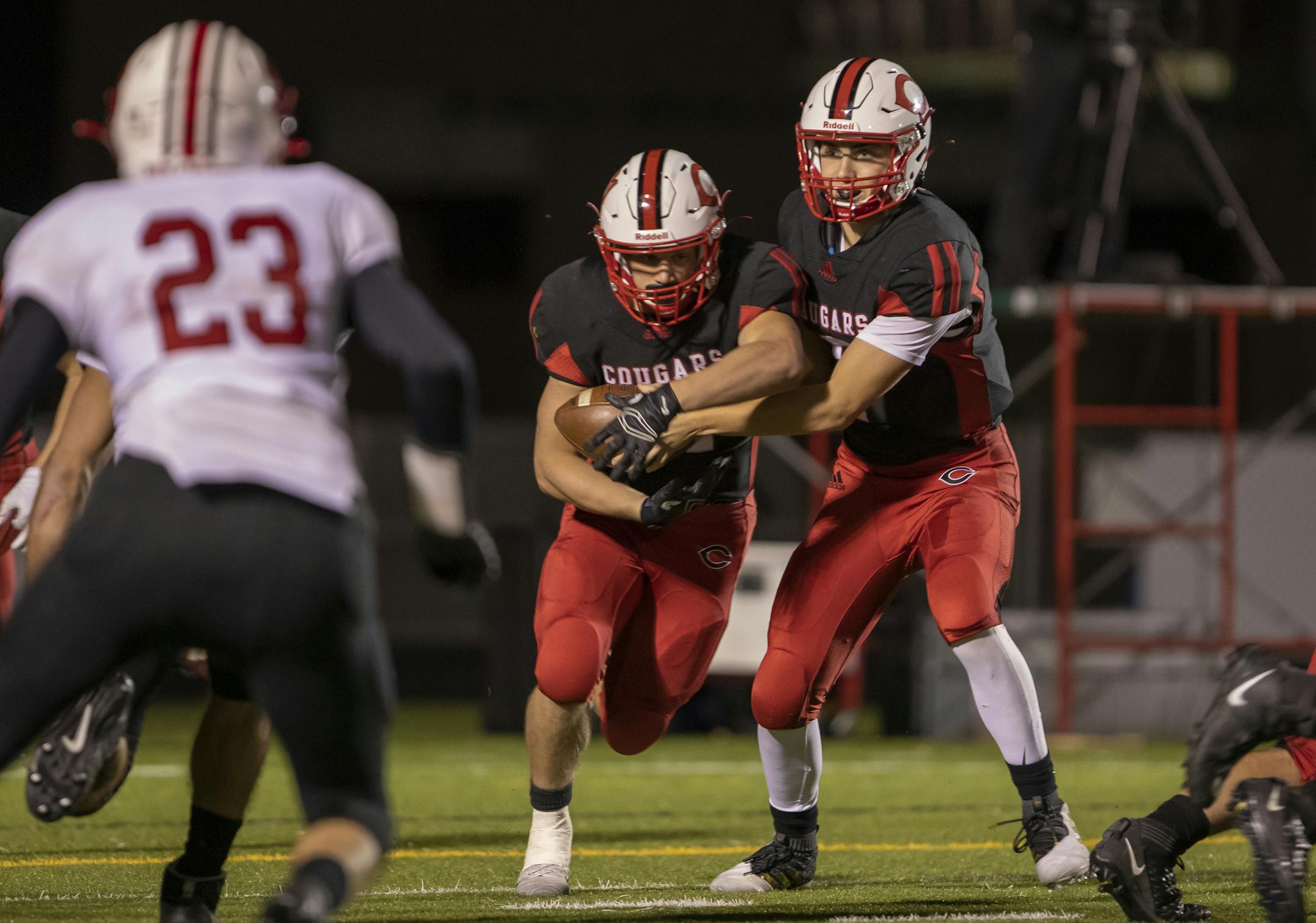 Centennial quarterback Connor Zulk (7) hands the ball to running back Noah Larson (21). [ Special to Star Tribune, photo by Matt Blewett, Matte B Photography, matt@mattebphoto.com, October 25, 2019, Stillwater at Centennial, MSHSL football, Centennial High School, Minnesota, SAXO 1009807806 PREP102619.cent