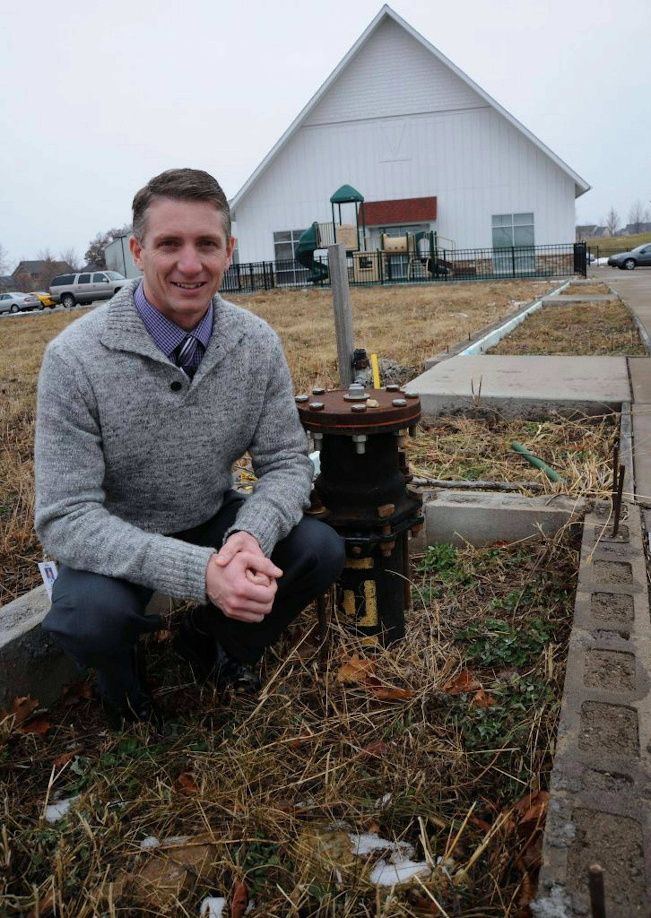 Liberty Ridge Elementary School principal Mike Moore, sat next to a utility stem in the bare ground and foundation pad where the school can expand to. The building in the background is"Liberty Ridge Site II", a building next to the main school that the school has used to expand classrooms into.