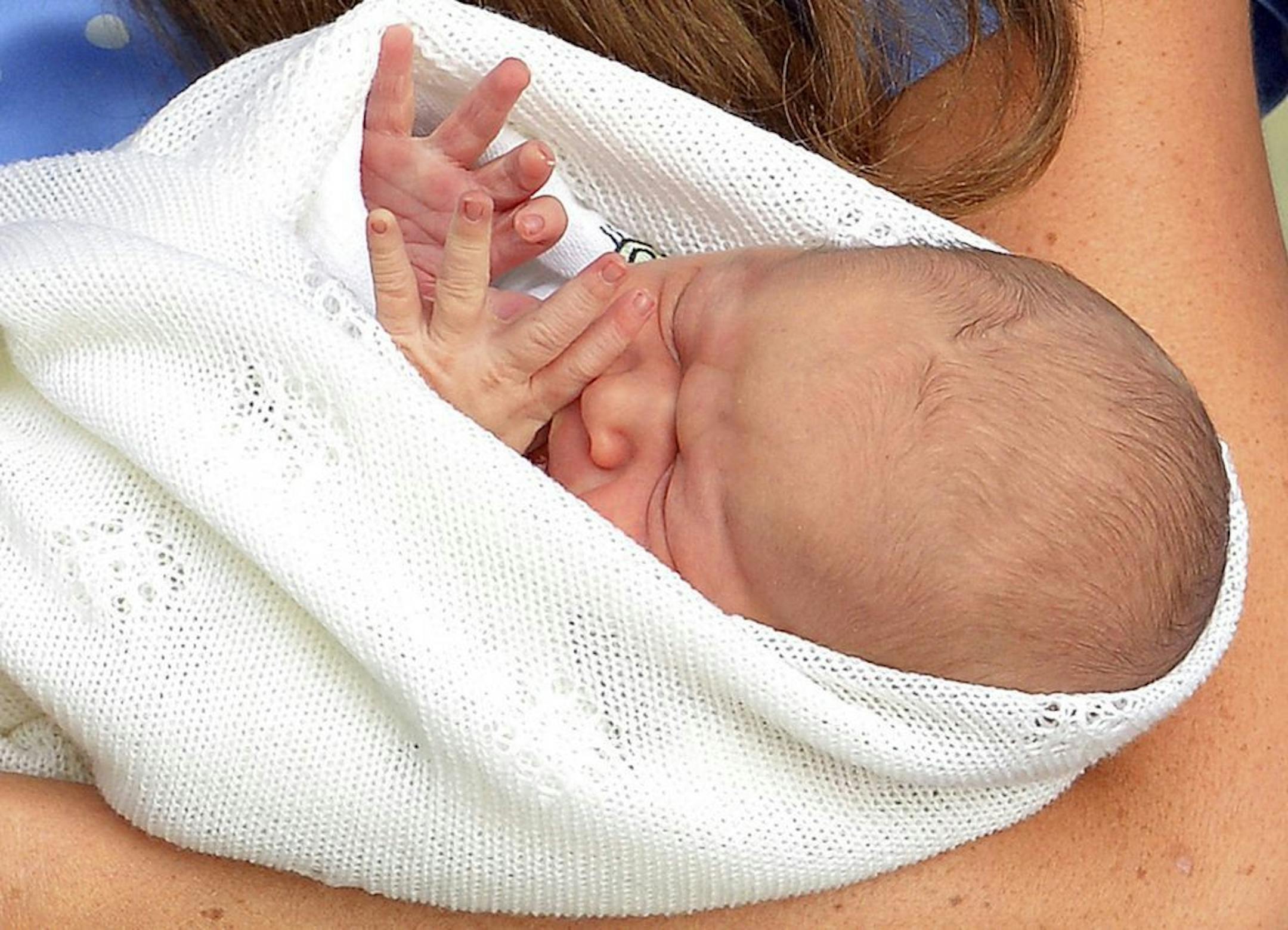 Kate, the Duchess of Cambridge, carries her new born son, the Prince of Cambridge, who was born on Monday. into public view for the first time. outside the Lindo Wing of St. Mary's Hospital, in London, Tuesday, July 23, 2013. The boy will be third in line to the British throne.