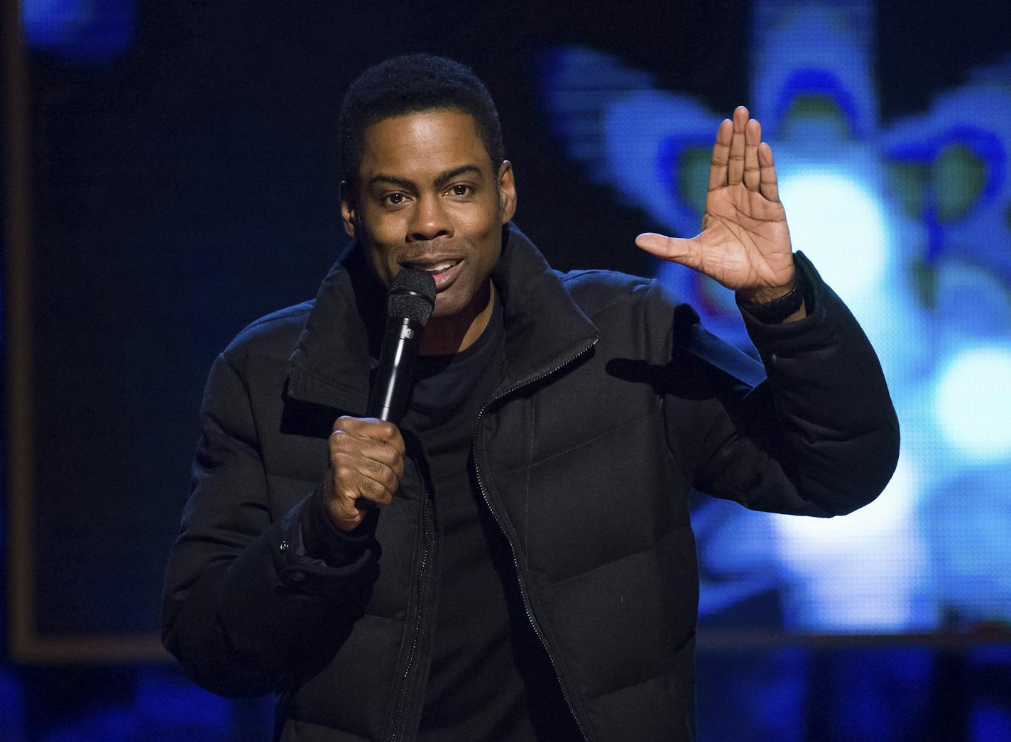 FILE - In this Feb. 28, 2015 file photo, comedian Chris Rock performs at Comedy Central's "Night of Too Many Stars: America Comes Together for Autism Programs" in New York. Netflix says the comedian is filming two stand-up specials after an eight-year absence. The first show will tape in 2017, following a new world tour. (Photo by Charles Sykes/Invision/AP, File) ORG XMIT: NYET445