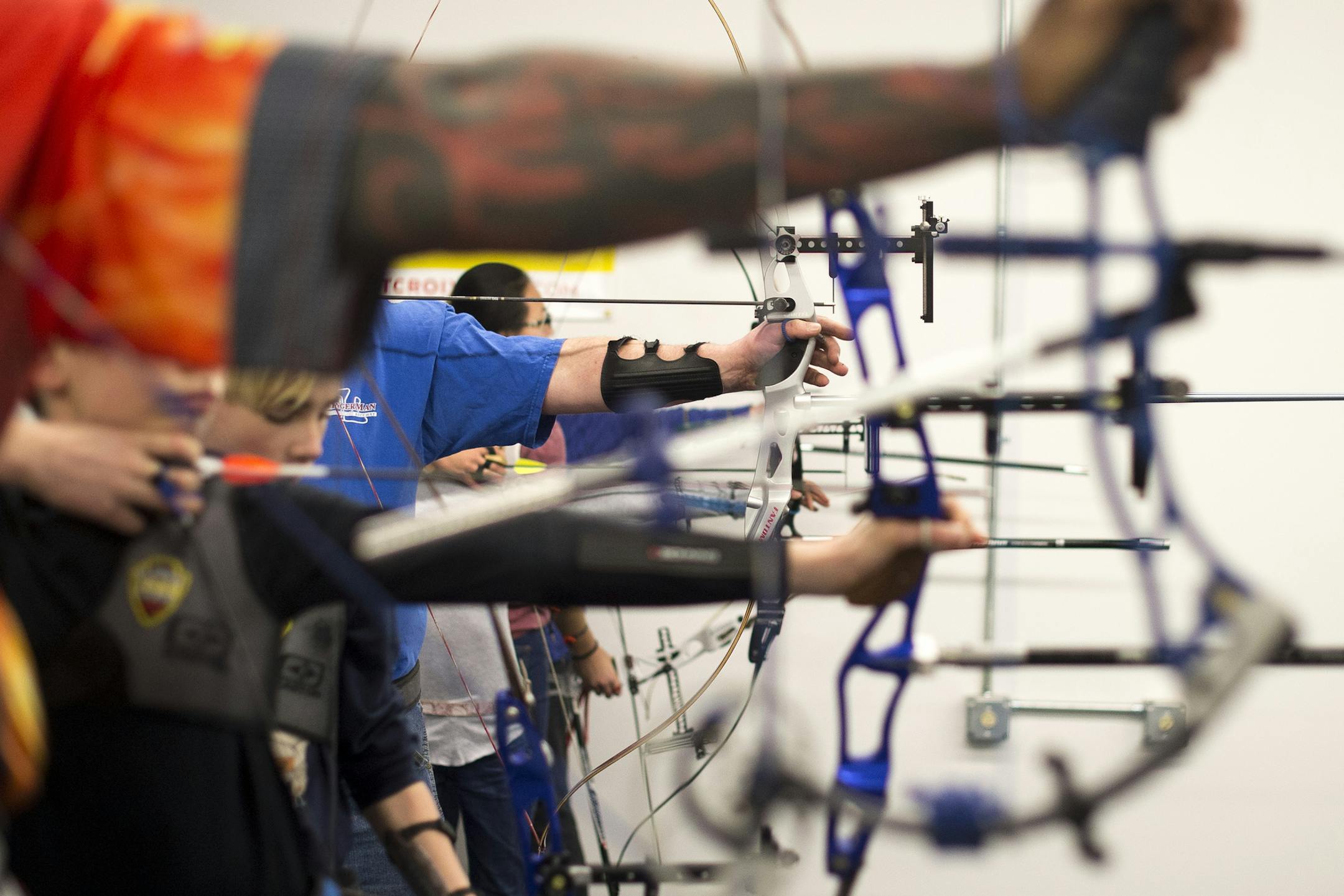 Archers at the Minnesota NorthStar Archery Club shoot at targets downrange on Tuesday night. ] (Aaron Lavinsky | StarTribune) Diane Kleinke and her family along with other archers practice shooting at the Minnesota NorthStar Archery Club in Woodbury. They were photographed Tuesday, Feb. 24, 2015.