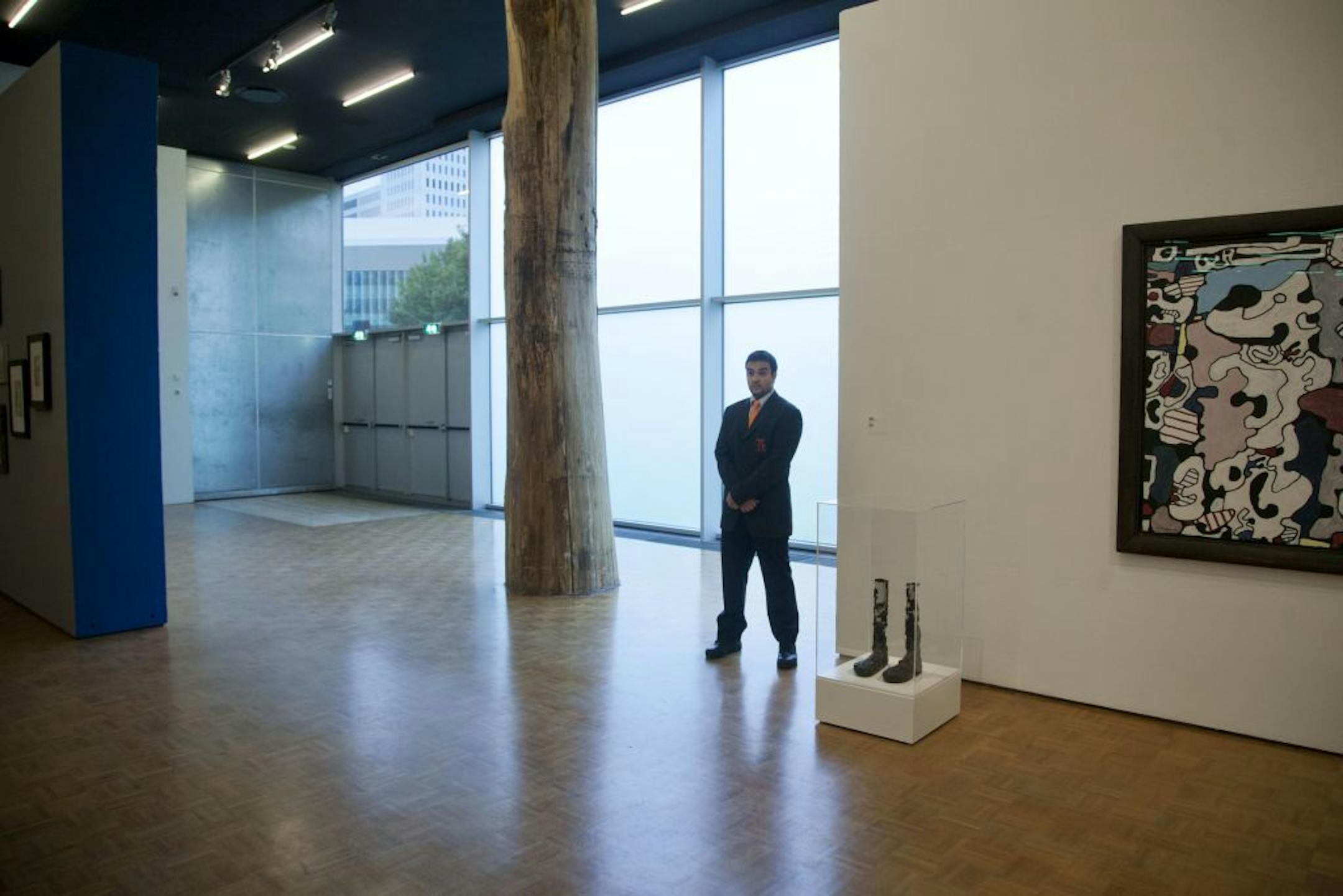 A security guard stands near the emergency exit doors used by thieves to carry seven stolen paintings out of Kunsthal museum, as the museum opened it's door to the public following early Tuesday morning's heist, in Rotterdam, Netherlands, Wednesday, Oct. 17, 2012. Police investigating a multimillion euro (dollar) art heist say they are following up several tips from the public, a day after thieves grabbed seven paintings from the walls of a Rotterdam gallery and vanished into the night. A spokes