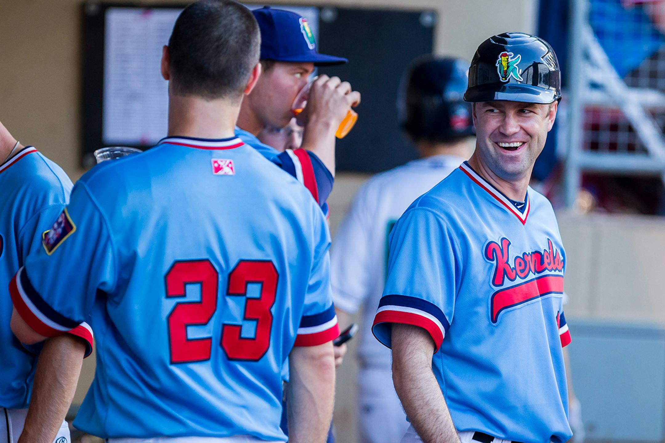 Kernels manager Jake Mauer congratulates his brother Joe for scoring a run in the bottom of the third inning at Perfect Game Field in Cedar Rapids Tuesday evening, August 5, 2014. (Bill Adams/Freelance)