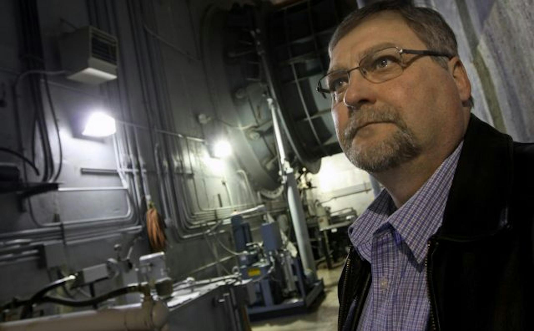(left to right) John Zgoda, Hastings Public Works Director stood under one of the huge tubes that house one of two water turbines at the Hastings Hydroelectric plant. The power plant is located at Lock and Dam #2, on the Mississippi river, just north of downtown Hastings.