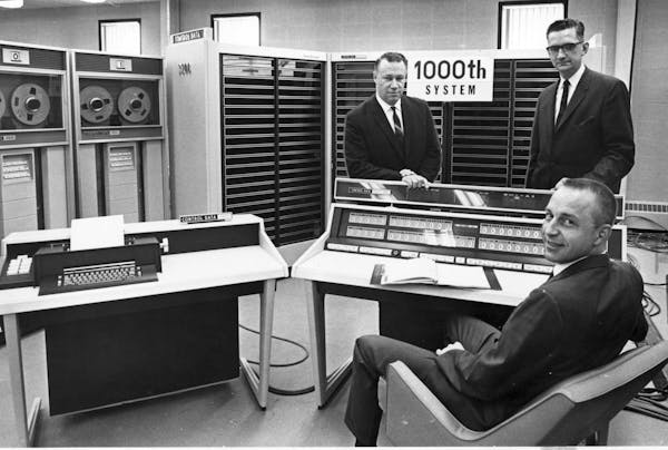 Executives of Control Data Corp. marked completion of the company’s 1000th computer system in 1965. This Control Data 3200 was assembled at the comp