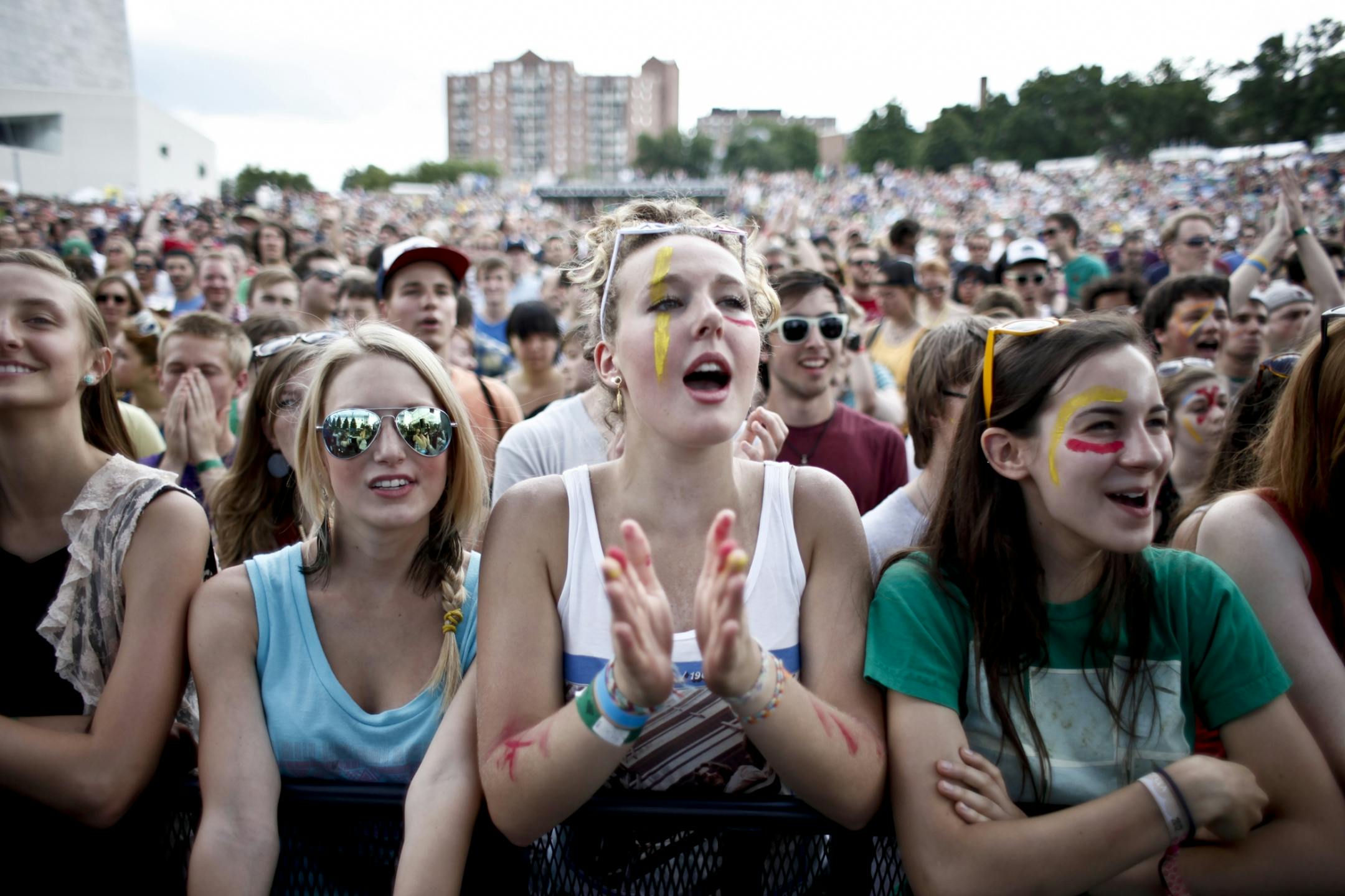 Megan Pohle, 16, middle reacts to the lead singer of Tune-yards Merrill Garbus as she enters the stage to set tone of the 2012 Rock the Garden concert in Minneapolis, Minn. on Saturday, June 16, 2012.