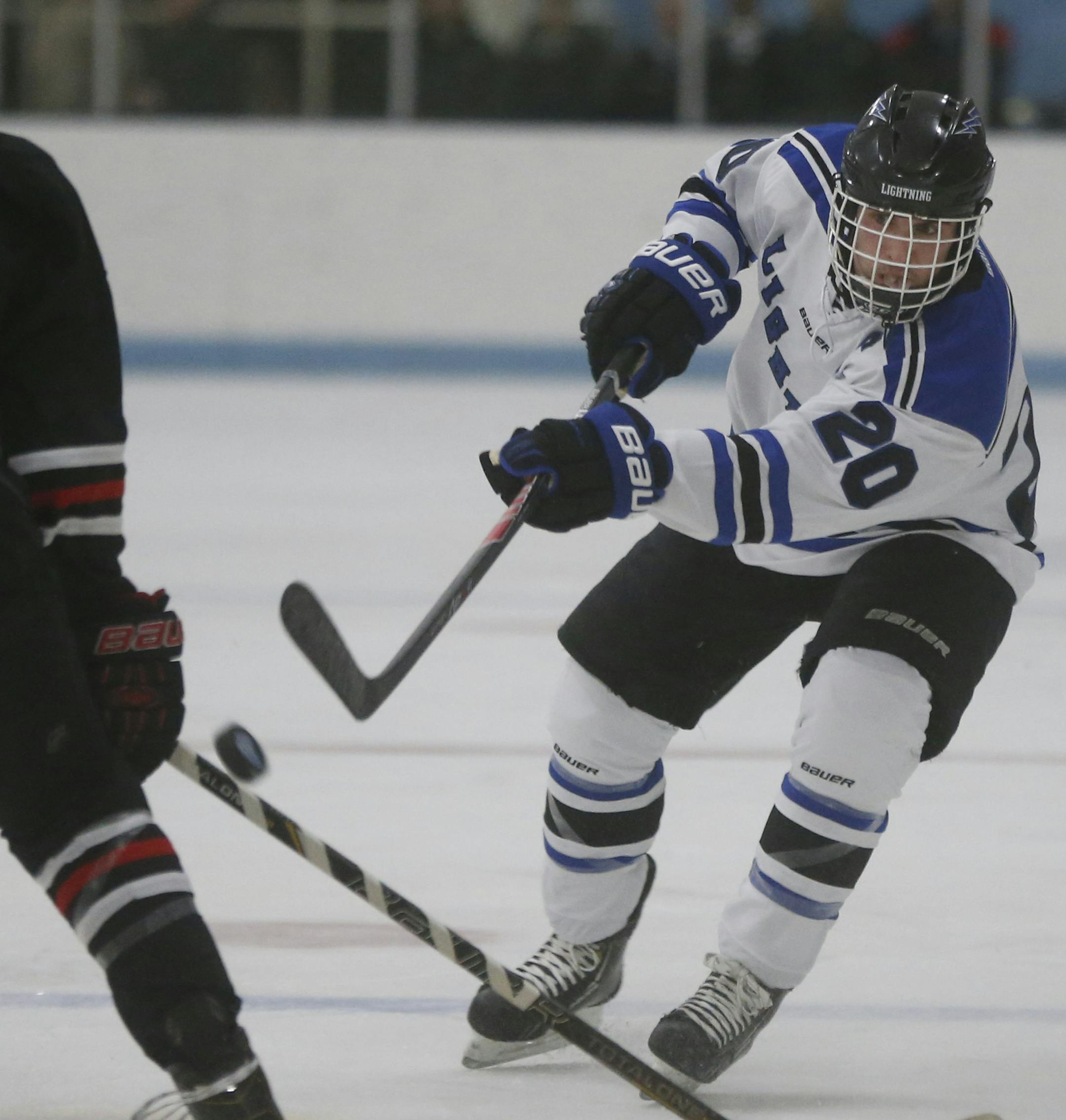 In a boy's hockey game between Eastview H.S.and Lakeville North, Jake McGlocklin(20) puts the puck in play .]richard tsong-taatarii/rtsong-taatarii@startribune.com