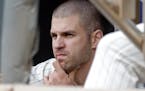 Minnesota Twins' Joe Mauer watches from the dugout during the first game of a baseball doubleheader against the Detroit Tigers on Thursday.