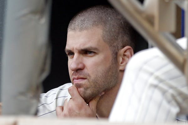 Minnesota Twins' Joe Mauer watches from the dugout during the first game of a baseball doubleheader against the Detroit Tigers on Thursday.