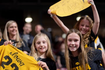 Annabel Clay, 9, Ella Dreier, 9, and Savannah Desautel, 9, of Chaska posed for a photo during warmups.