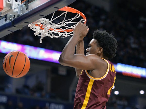 Gophers sophomore Joshua Ola-Joseph dunked during the second half of Saturday's victory at Penn State.