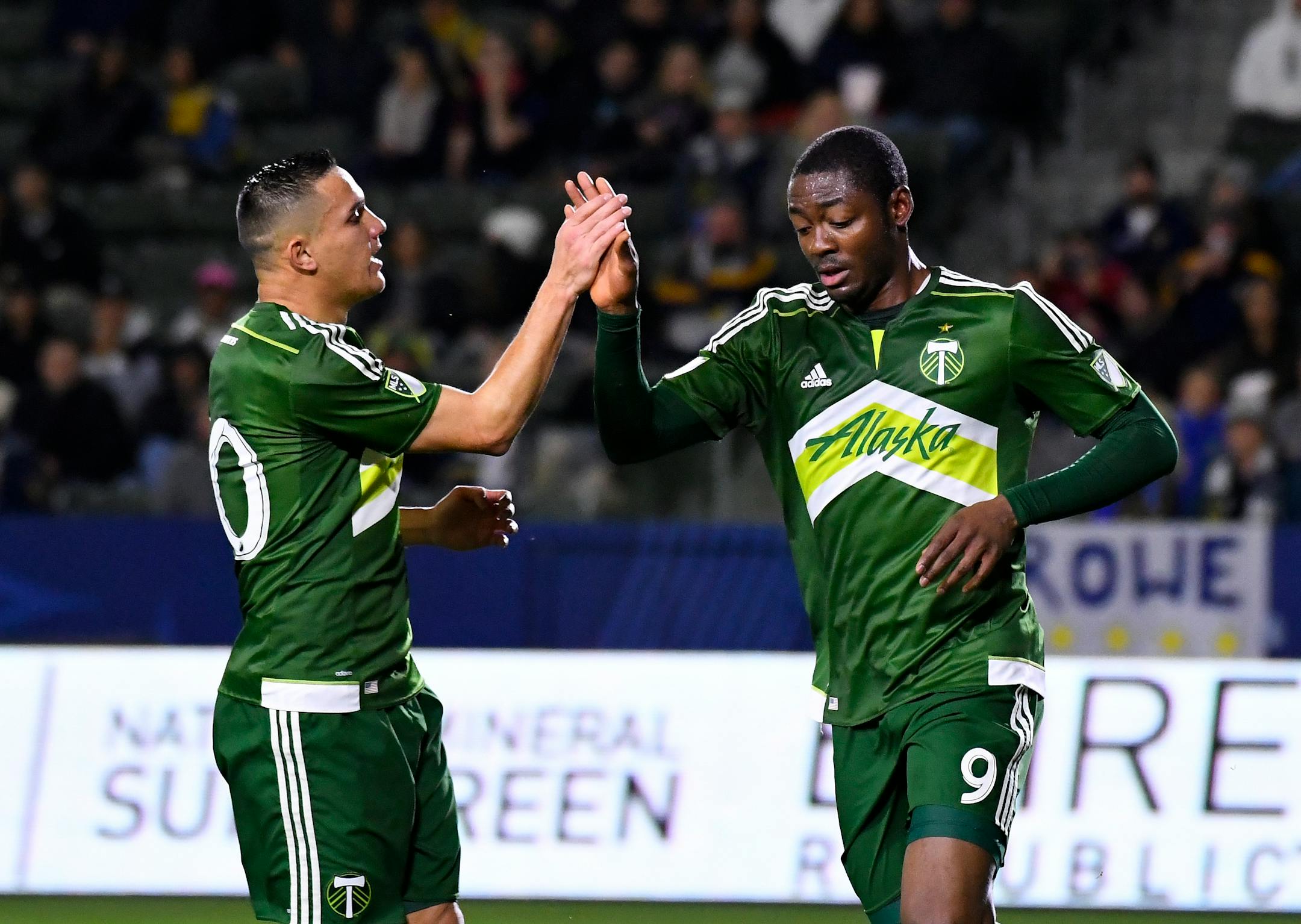 David Guzman, left, and Fanendo Adi of the Portland Timbers.