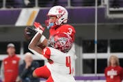 Mankato West's Jalen Smith (3) makes a catch while defended by Elk River's Darioh Balisidya (4) in the first half of the Minnesota High School footbal