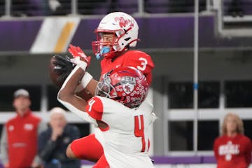 Mankato West's Jalen Smith (3) makes a catch while defended by Elk River's Darioh Balisidya (4) in the first half of the Minnesota High School footbal