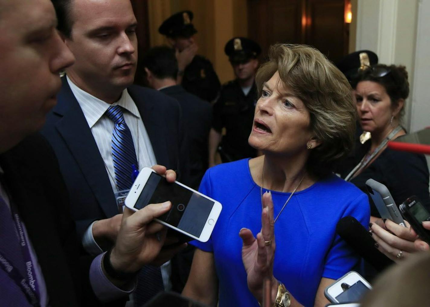 Sen. Lisa Murkowski, R-Alaska is surrounded by reporters as she walks toward the Senate floor on Capitol Hill in Washington, Tuesday, July 18, 2017.