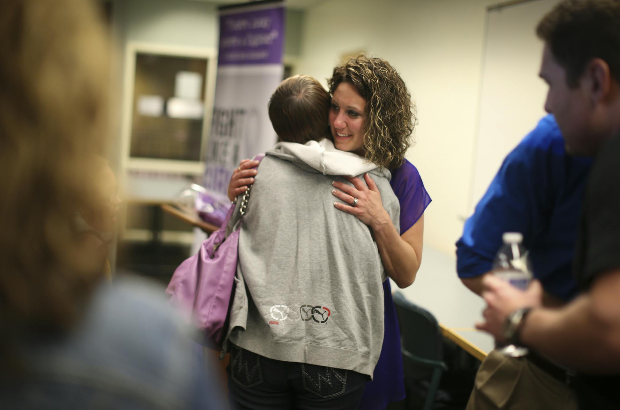 Angela Champagne-From hugged her best friend Krysti Clark-Garber after she spoke to a group of people as part of her Fight Like a Girl campaign at City Hall in Blaine, Minn., on Tuesday June 4, 2013. A year ago she escaped from a man who had attacked and stabbed her in a downtown parking ramp. ] (RENEE JONES SCHNEIDER * reneejones@startribune.com) Krysti CQ