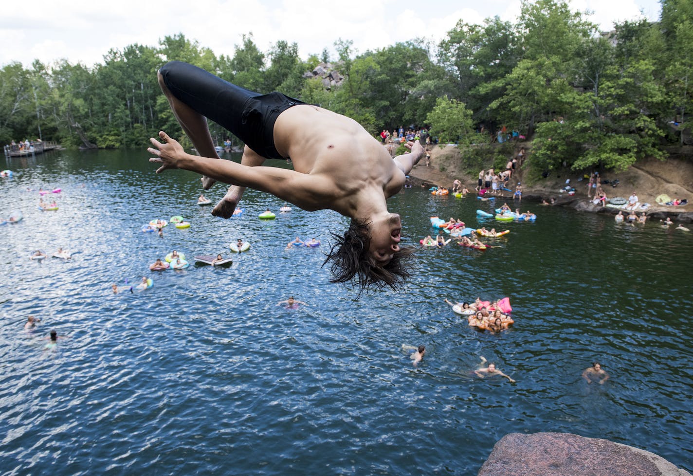 Mason Schmitt, of Maple Grove, did a flip off a cliff at quarry number 2 at Quarry Park and Nature Reserve on Saturday. ] Isaac Hale &#x2022; isaac.hale@startribune.com People took to the swimming holes at Quarry Park and Nature Reserve in St. Cloud, MN, on Saturday, July 30, 2016. One of the more popular areas to swim in Minnesota, the park attracts families as well as teenagers and young adults who jump off some of the cliffs surrounding the waters.