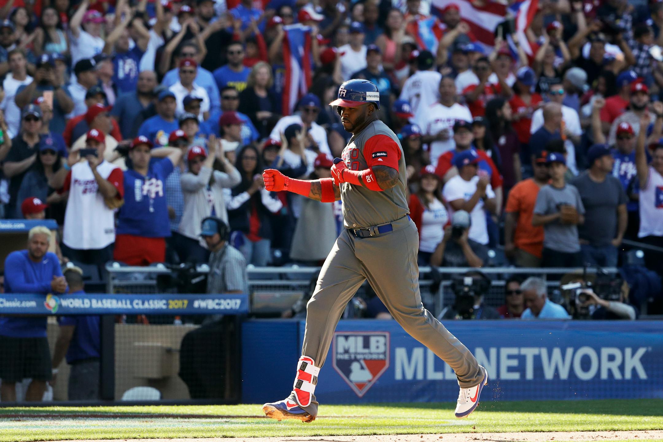 Puerto Rico's Kennys Vargas pounded his chest as he made his way towards home plate after hitting a two-run home run during the ninth inning of a second-round World Baseball Classic baseball game against Venezuela on Saturday.
