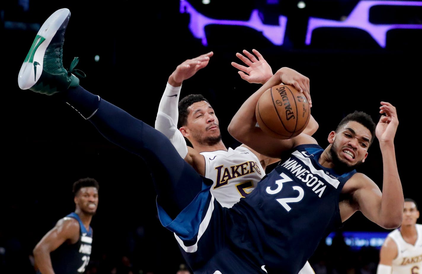 Minnesota Timberwolves center Karl-Anthony Towns, battles Los Angeles Lakers guard Josh Hart for a rebound during the second half of an NBA basketball game in Los Angeles, Monday, Dec. 25, 2017. The Timberwolves won 121-104. (AP Photo/Chris Carlson)