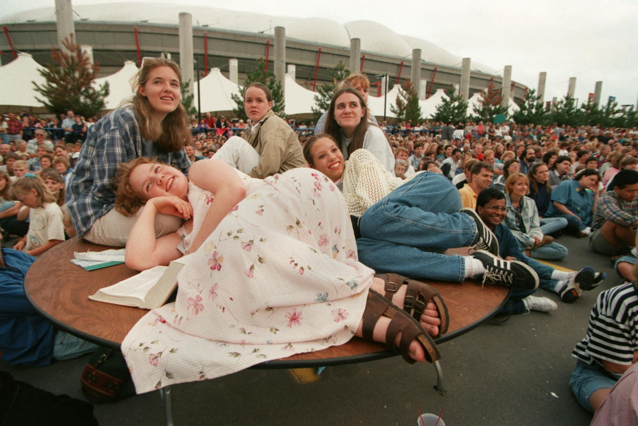 On the last day of Billy Graham's visit, Alyssa Sommer, Sara Rummel, Gina Jost, Jenny Harris and Sarah Rust, clockwise from front, watched Graham on a large screen just outside the Metrodome in Minneapolis Sunday. "Wow," was all of their consensus when asked about Graham. "His message is so awesome and perfect," Sommer added.