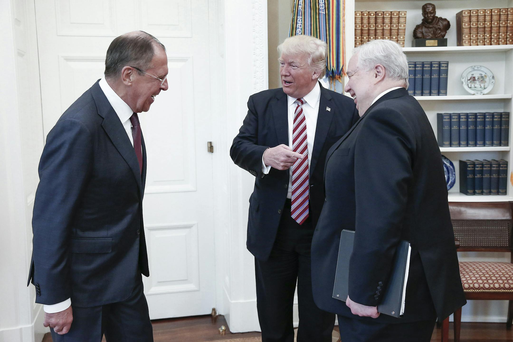 From left, Russia's Foreign Minister Sergei Lavrov, U.S. President Donald Trump, and Russian Ambassador to the United States Sergei Kislyak talk during a meeting in the Oval Office at the White House on Wednesday, May 10, 2017 in Washington, D.C. Kislyak is headed back to Russia. (Alexander Shcherbak/TASS/Abaca Press/TNS) ORG XMIT: 1207029