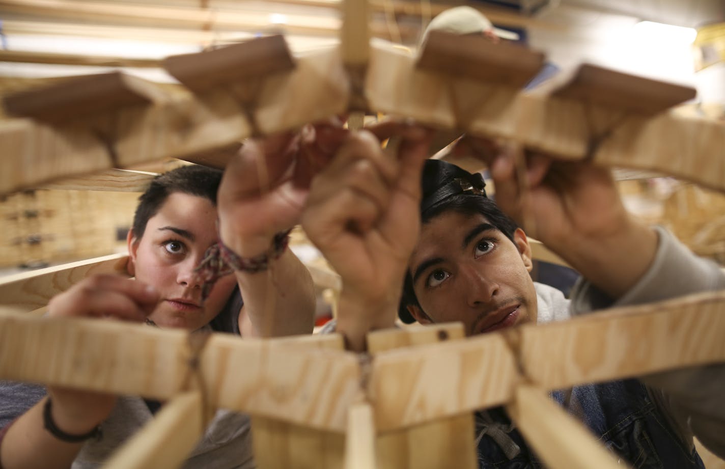 As part of the day of philanthropy, Lily Vraa and Joseph Romero lashed the floorboards to the frame of the kayak they built at Urban Boatbuilders in St. Paul.