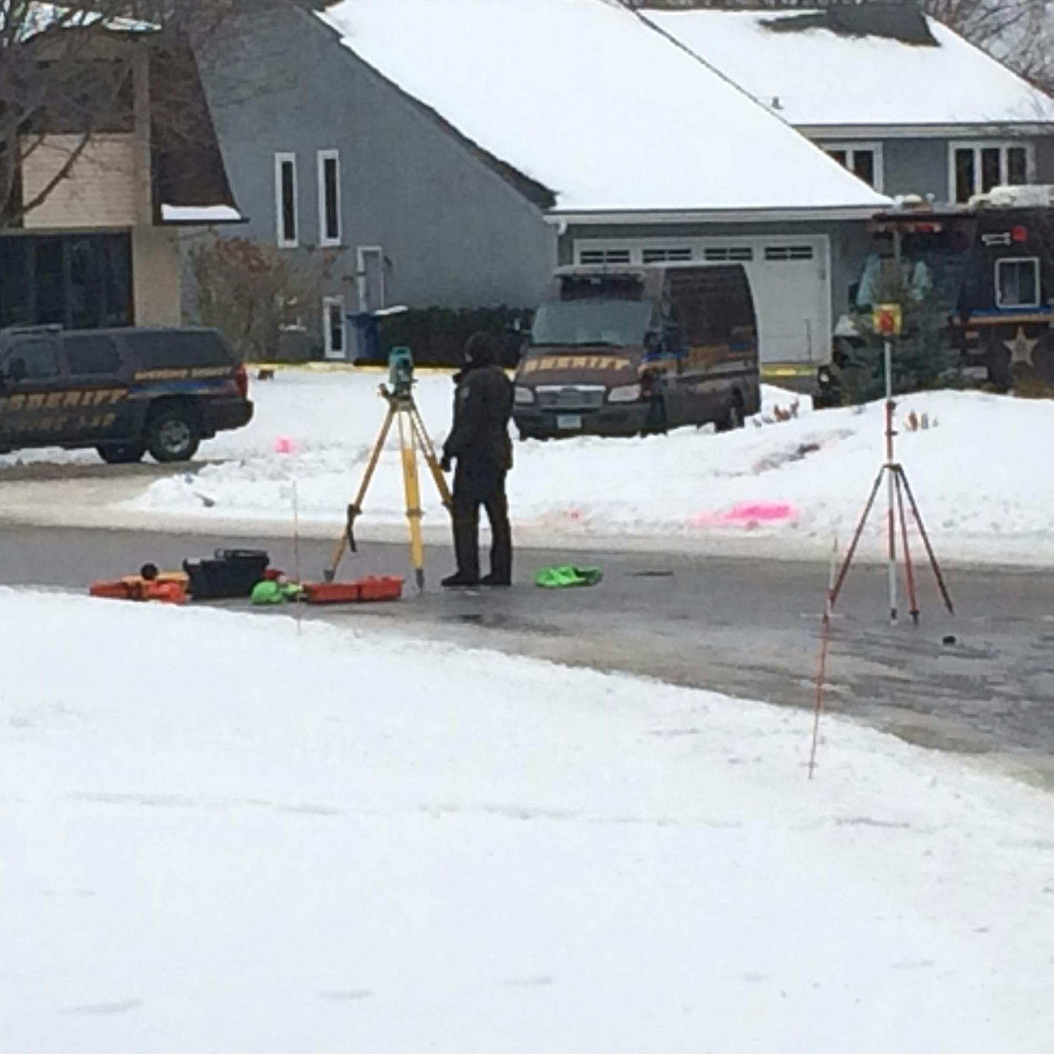Photo by John Reinan: Hennepin County investigators at the scene of the officer-involved shooting in Bloomington. The pink spray paint marks the area where a suicidal man was fatally shot.