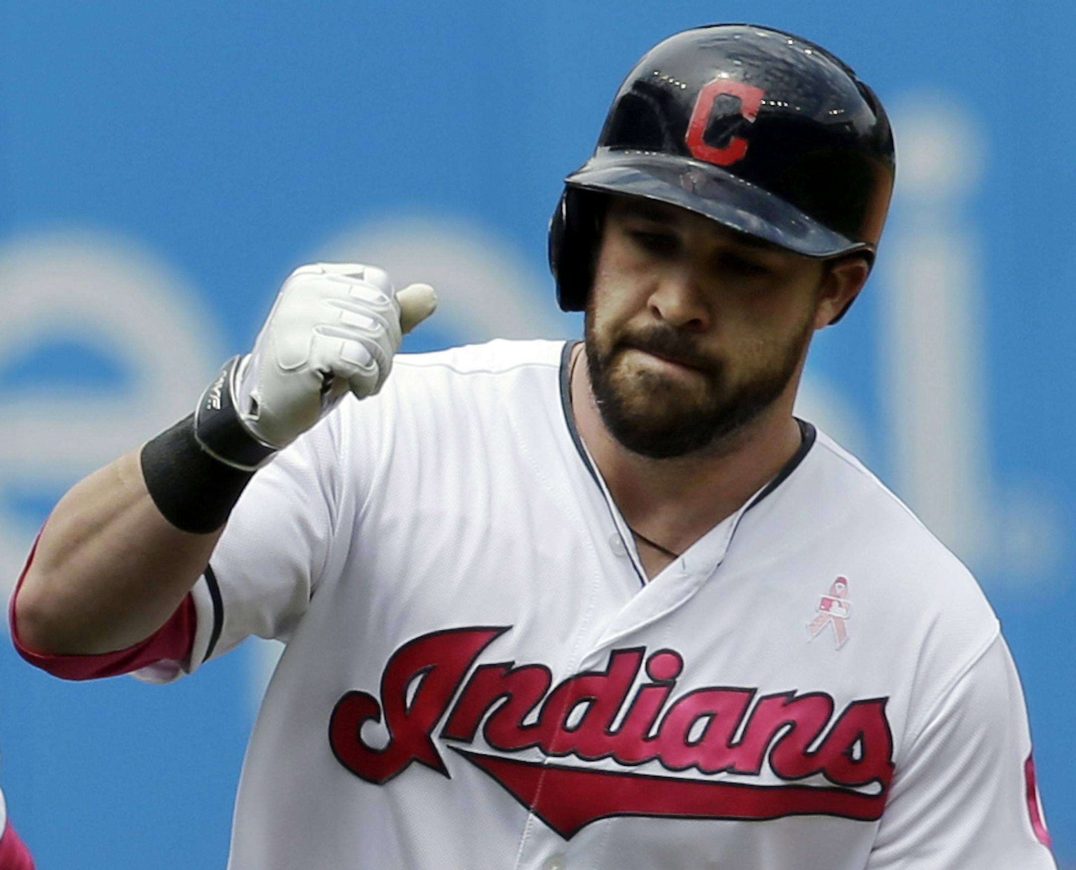 Cleveland Indians' Jason Kipnis, right, is congratulated by third base coach Mike Sarbaugh after hitting a solo home run off Minnesota Twins' Hector Santiago in the first inning of a baseball game, Sunday, May 14, 2017, in Cleveland. (AP Photo/Tony Dejak)