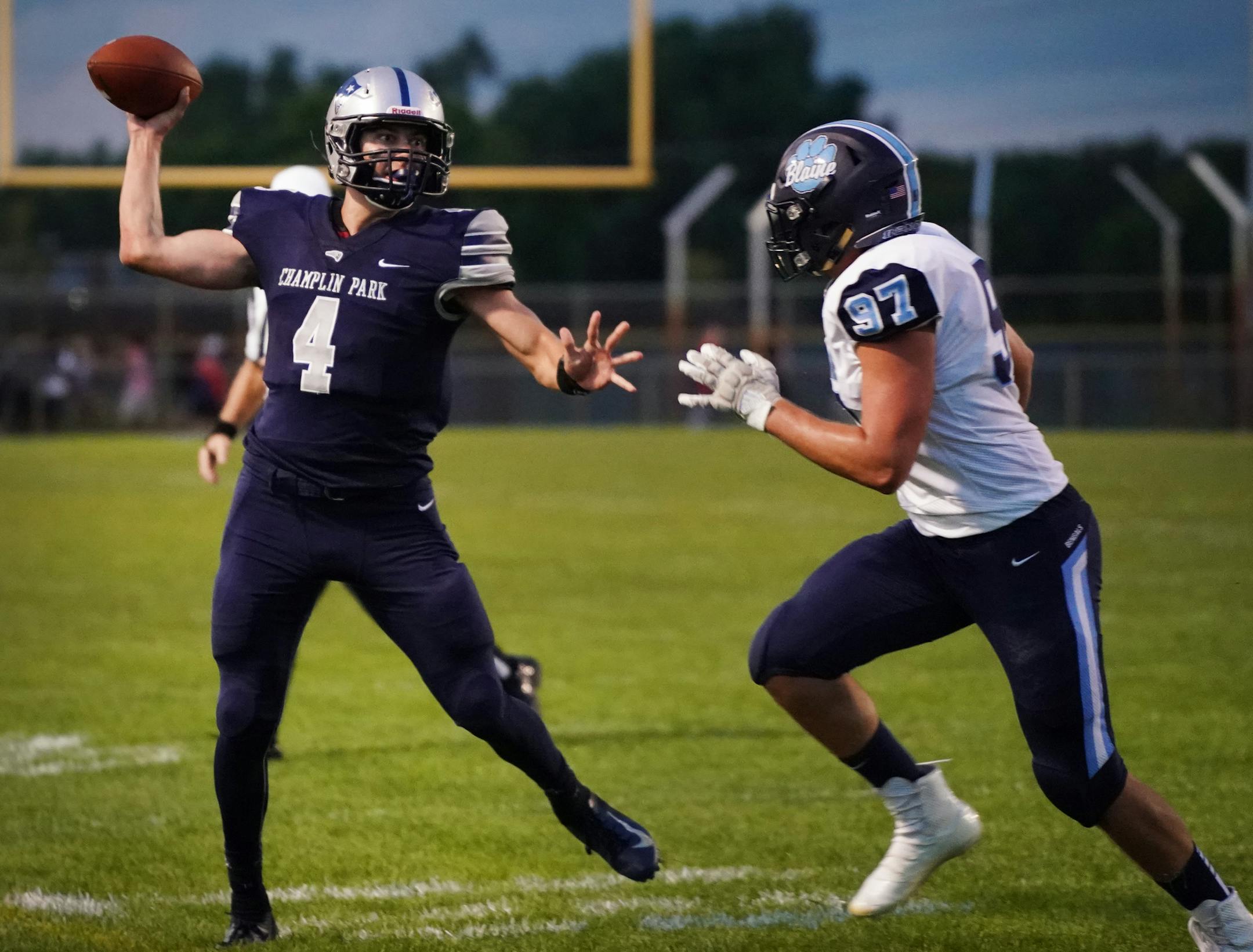 Champlin Park quarterback Jaice Miller (4) was pressured by Blaine defensive lineman Adam Brisson (97) in the first half. ] Shari L. Gross ¥ shari.gross@startribune.com The Champlin Park Rebels hosted the Blaine Bengals for a prep high school football game on Friday, Sept. 6, 2019.