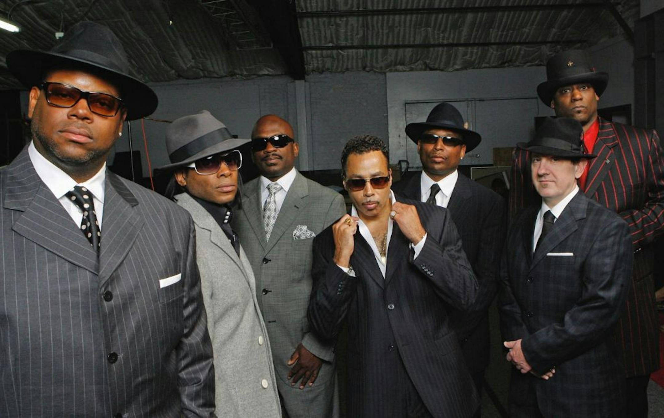 Jimmy Jam, Jesse Johnson, Jerome Benton, Morris Day, Terry Lewis, Monte Moir and Jellybean Johnson wearing suits.
