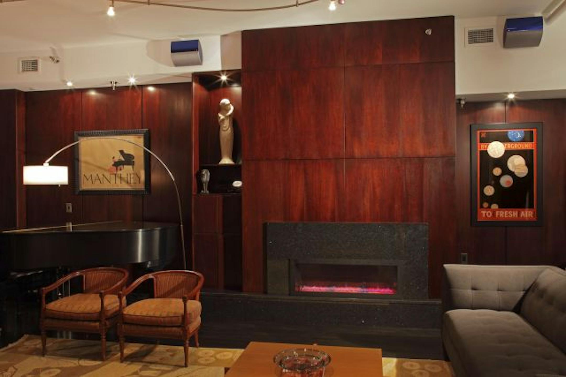 After: Rich mahogany panels cover the fireplace wall