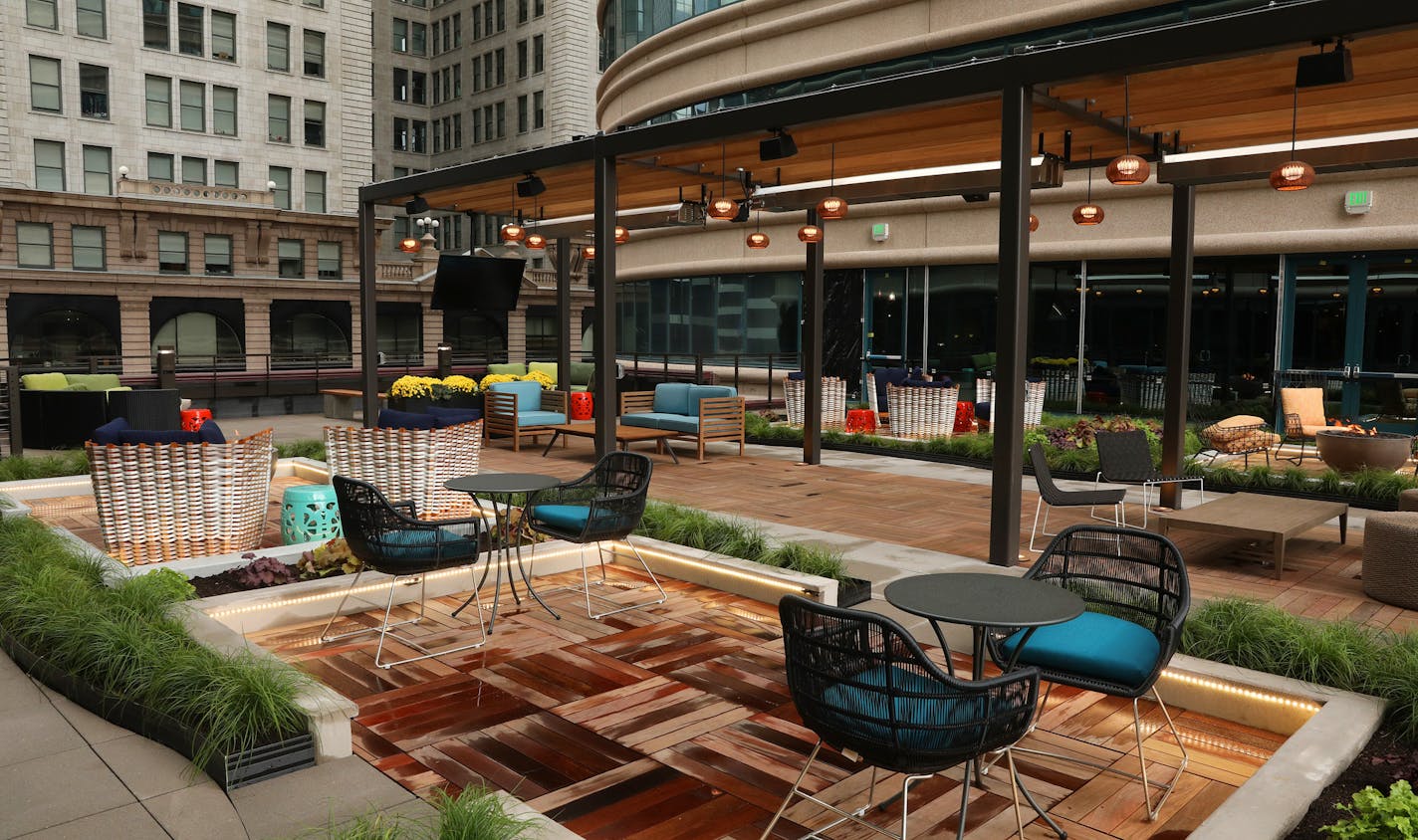 Seating areas and fire pits adorn the new outdoor terrace at Fifth Street Towers. ] ANTHONY SOUFFLE &#xef; anthony.souffle@startribune.com A look at Fifth Street Towers' recently completed multimillion-dollar renovation that includes a new bar on second level, a newly redone lobby, an outdoor space, and nap pods seen Tuesday, Sept. 26, 2017 in Minneapolis.