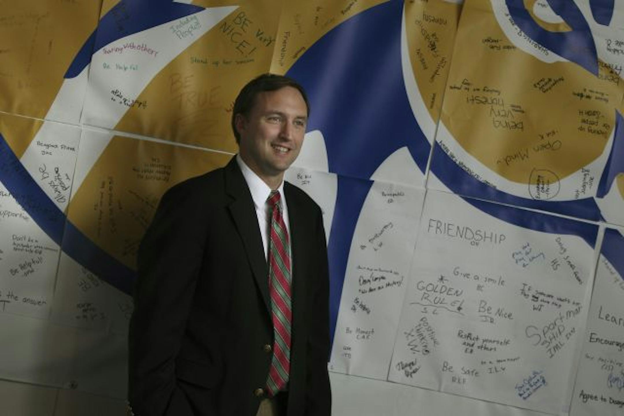 Breck Middle School Director Sky Fauver stood by a poster with the school mascot and signatures from staff and students professing to be an anti-bullying school.