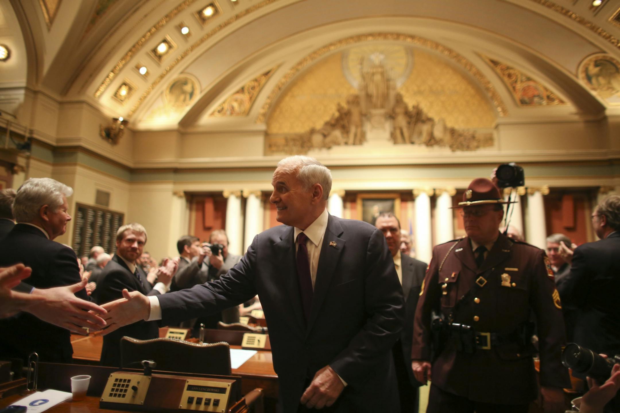 Minnesota Gov. Mark Dayton worked the aisle shaking legislators' hands after he delivered his State of the State speech on February 6, 2013.
