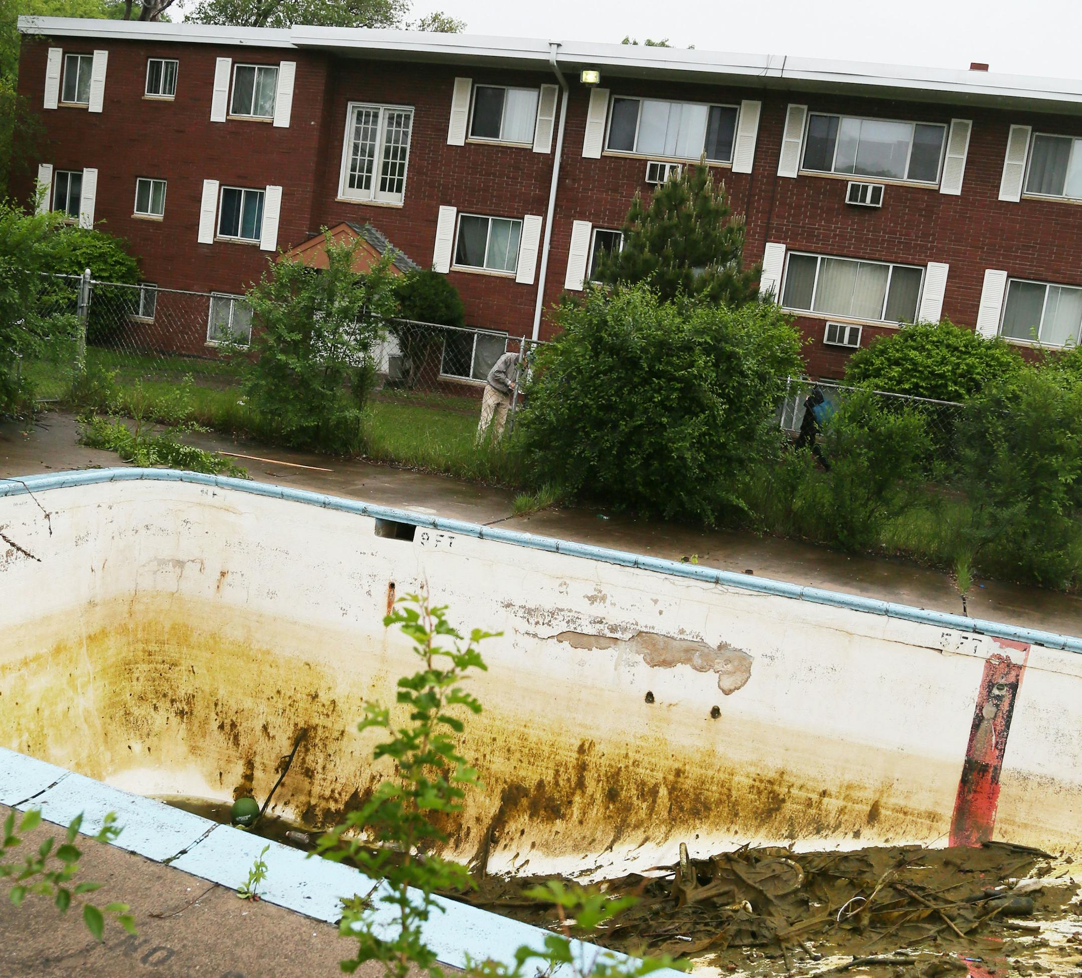 Rainwater sat in the bottom of an abandoned swimming pool in St. Paul on Monday from where firefighters pulled out two young brothers.