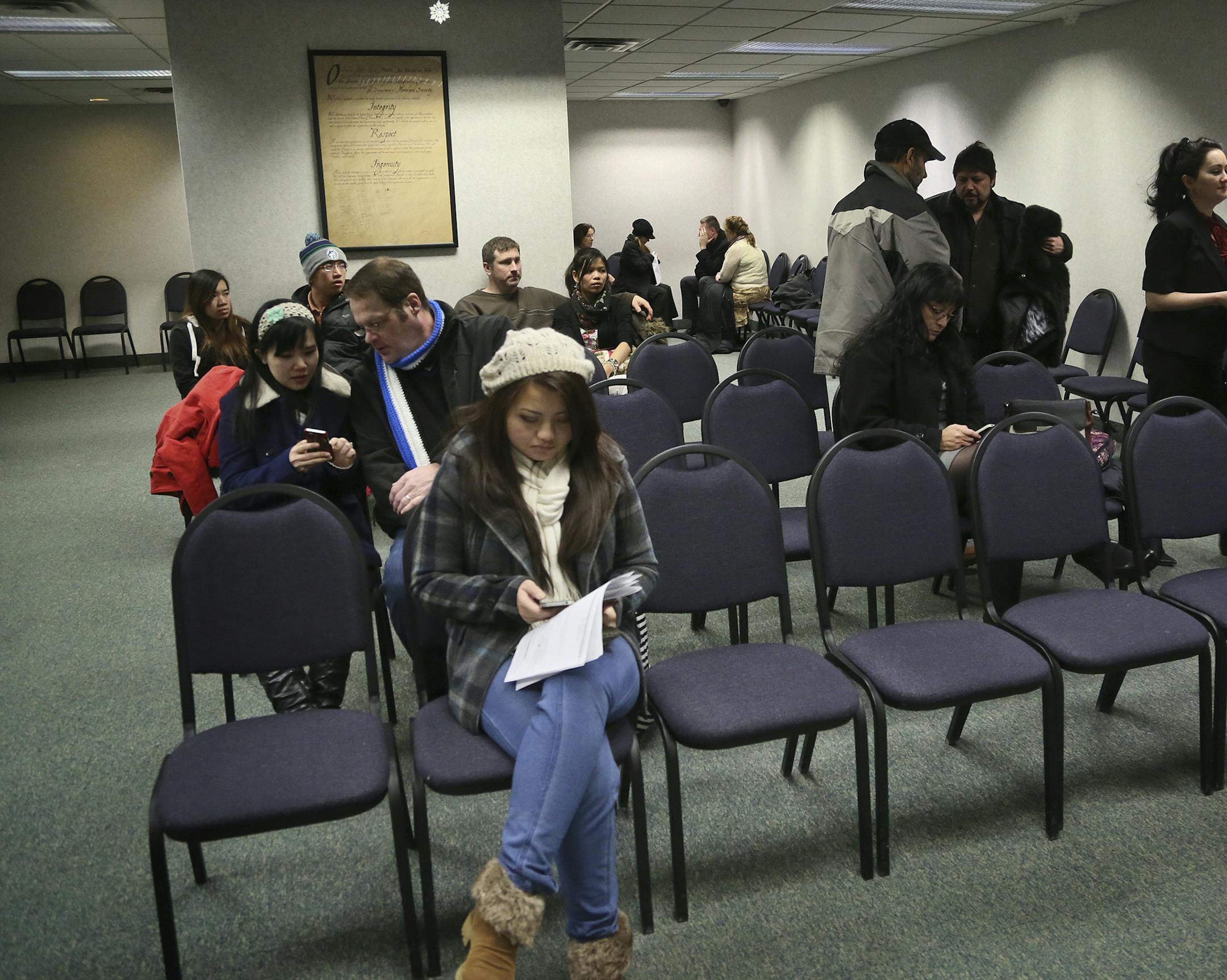 Immigrants with legal status and in some cases their spouses or friends, awaiting appointments sit in a waiting room at the US Customs and Immigration Services offices Thursday, Feb. 6, 2014, in Bloomington, MN.](DAVID JOLES/STARTRIBUNE) djoles@startribune.com Hundreds of immigrants who have had an easy bus ride to the US Customs and Immigration Services office to get green cards and visas will soon have to figure out how to get to the new federal immigration office that accidentally moved way o
