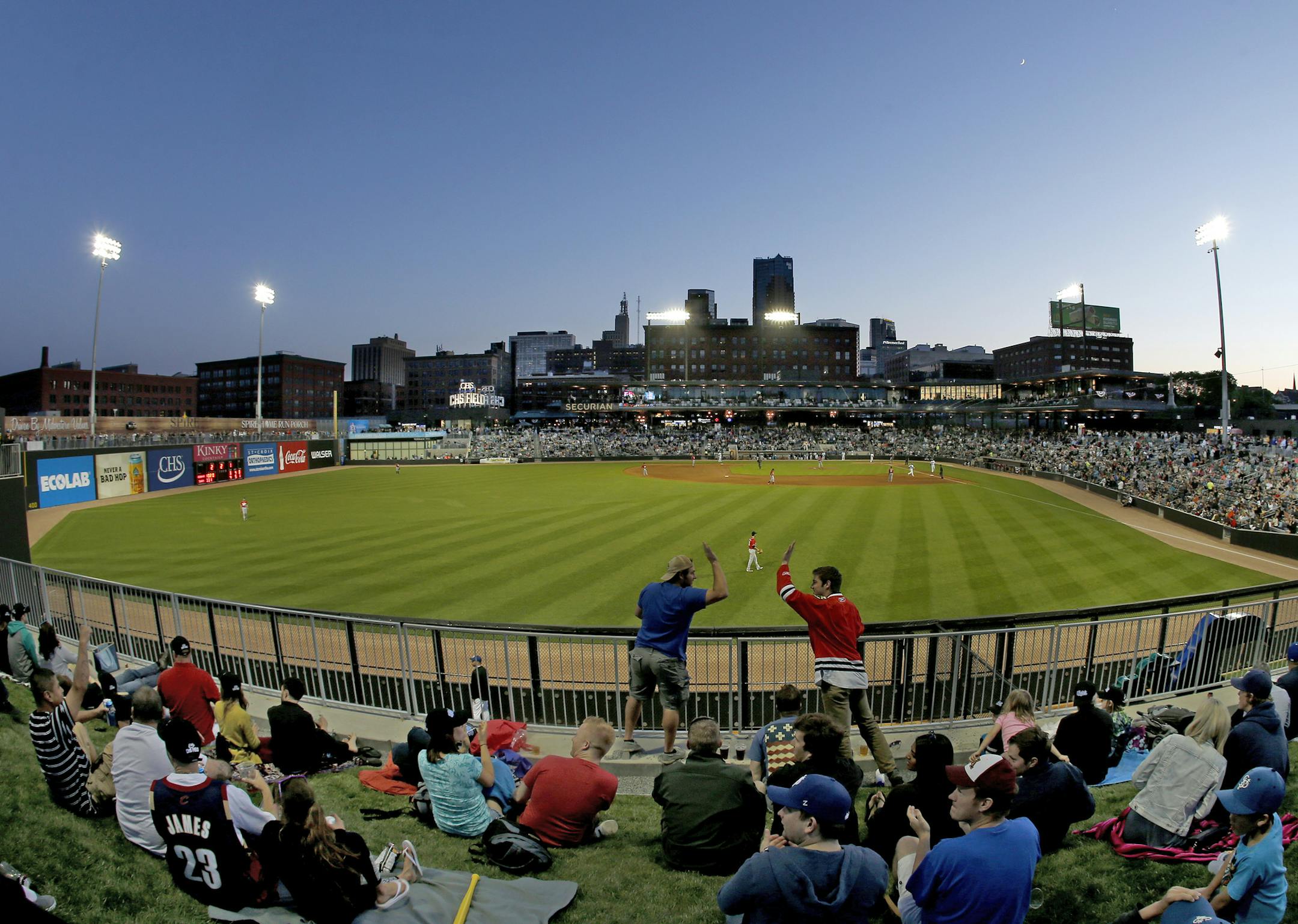 Fans celebrated a St. Paul Saints homerun in the fourth inning. ] CARLOS GONZALEZ cgonzalez@startribune.com, May 21, 2015, St Paul, MN, CHS Field, St. Paul Saints Baseball, First game at the new CHS Field ORG XMIT: MIN1505212103341818