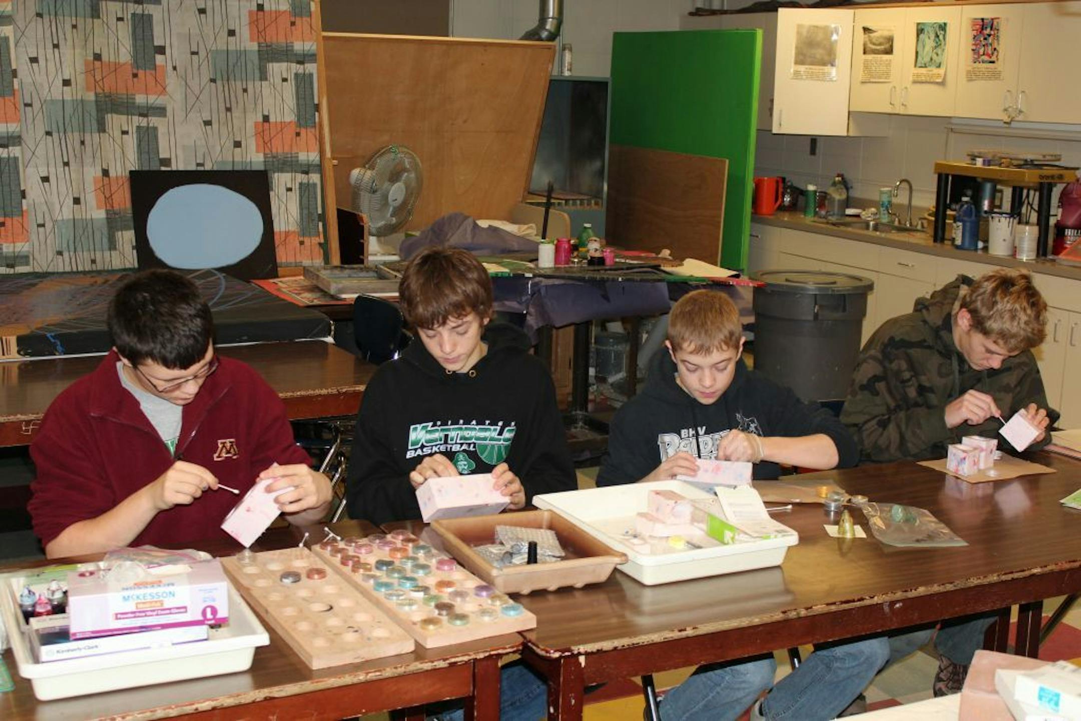 Students at Verndale Public School work on making plastic fish-head Christmas ornaments. Pictured are, from left to right: Zach Johnson 9th grade, of Verndale, Colter Ehrmantraut, 10th grade, of Wadena, Anthony Kern, 10th grade, of Verndale, and Brian Bertram, 12th grade, of Verndale.