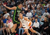 Las Vegas Aces guard Kelsey Plum (10) drove against the defense of Minnesota Lynx forward Kayla McBride (21) in the first quarter.