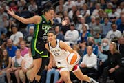 Las Vegas Aces guard Kelsey Plum (10) drove against the defense of Minnesota Lynx forward Kayla McBride (21) in the first quarter.