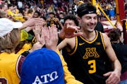 Gophers forward Dawson Garcia celebrates with the student section at the end of a game last month.