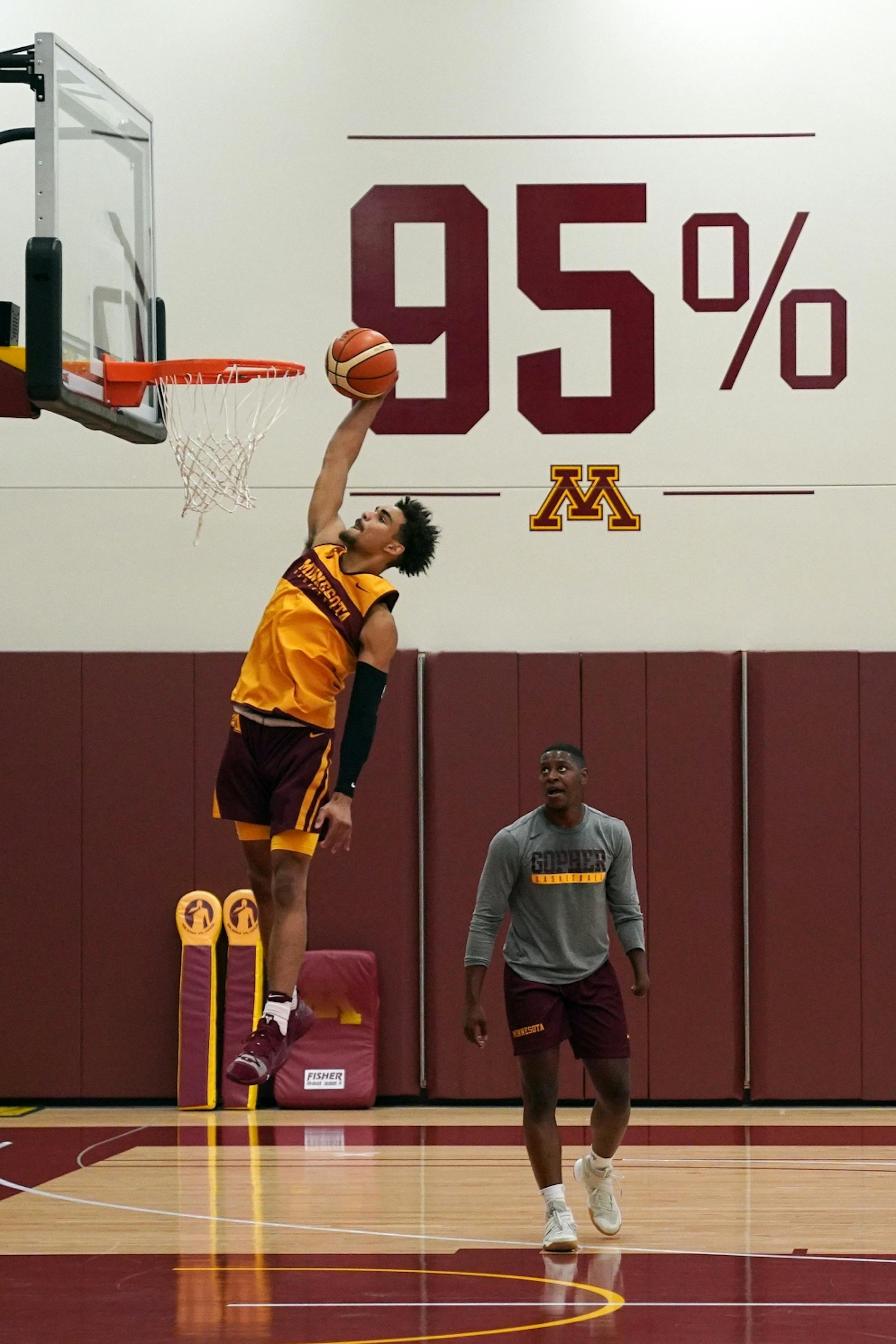 Gophers guard Tre' Williams (1) dunked the ball during Thursday's practice.