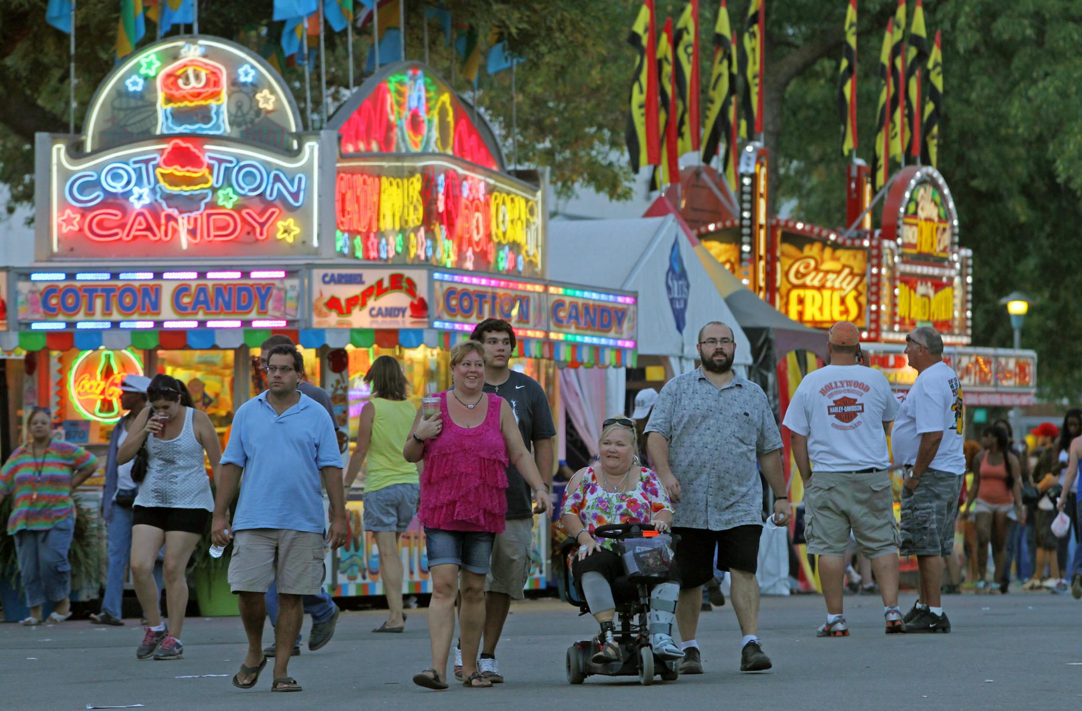The sun set on the streets of the Minnesota State Fair in Falcon Heights as the streets were jammed with people taking in the last day of the fair on 9/3/12.] Bruce Bisping/Star Tribune bbisping@startribune.com